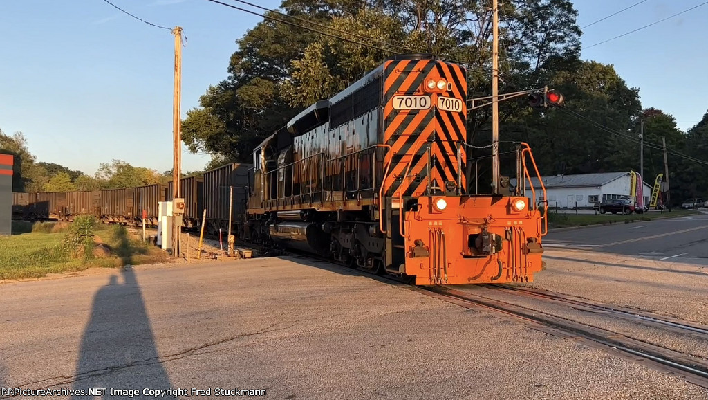WE 7010 comes back across Gilchrist Rd. with its train.